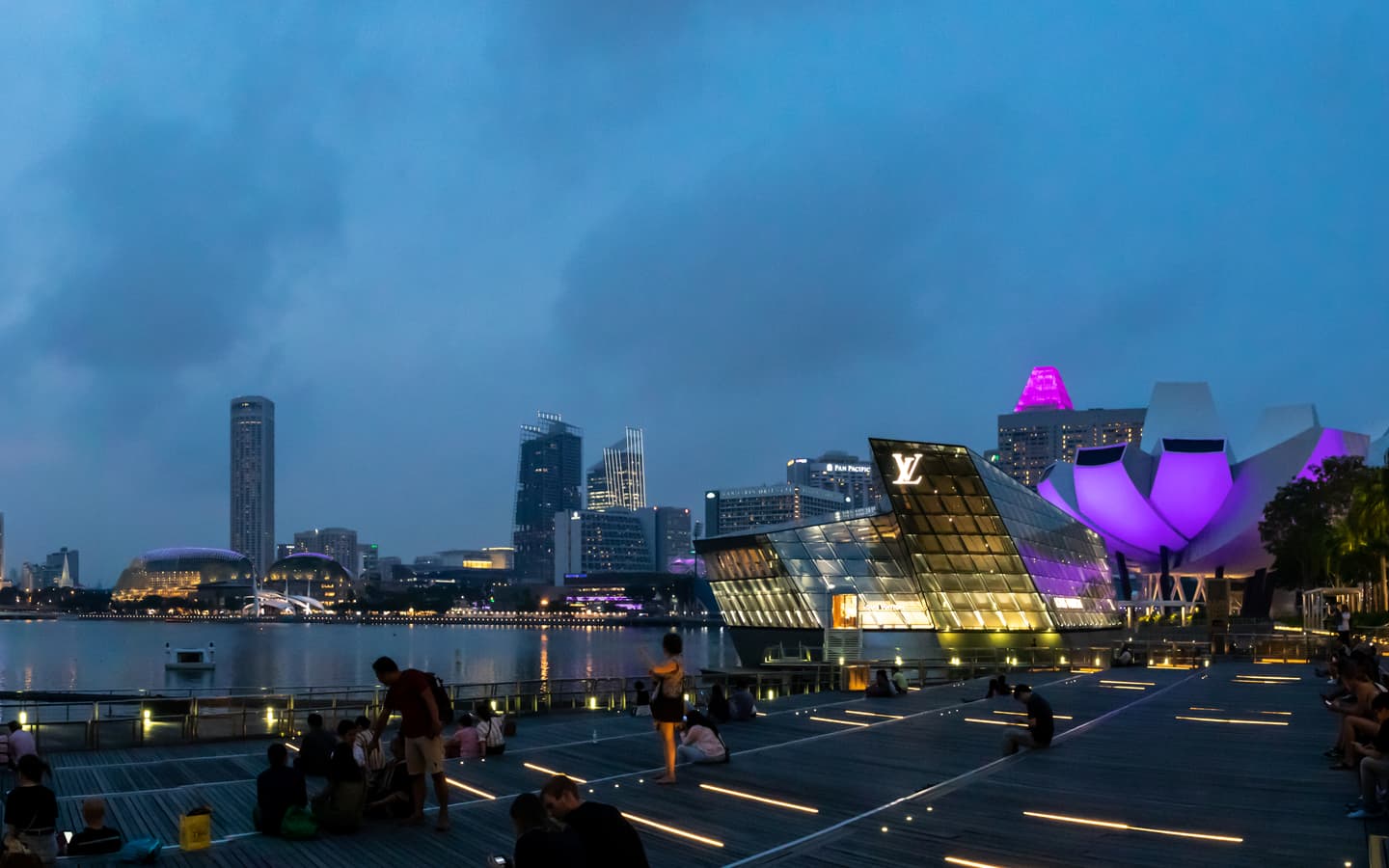 A panoramic night view of Marina Bay and Singapore waterfront skyscrapers